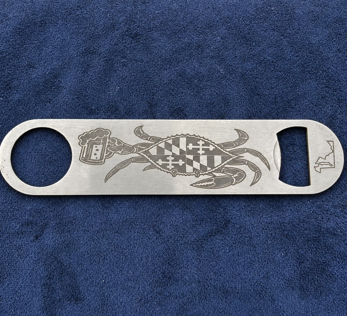Maryland flag crab holding a beer engraved on a bottle opener